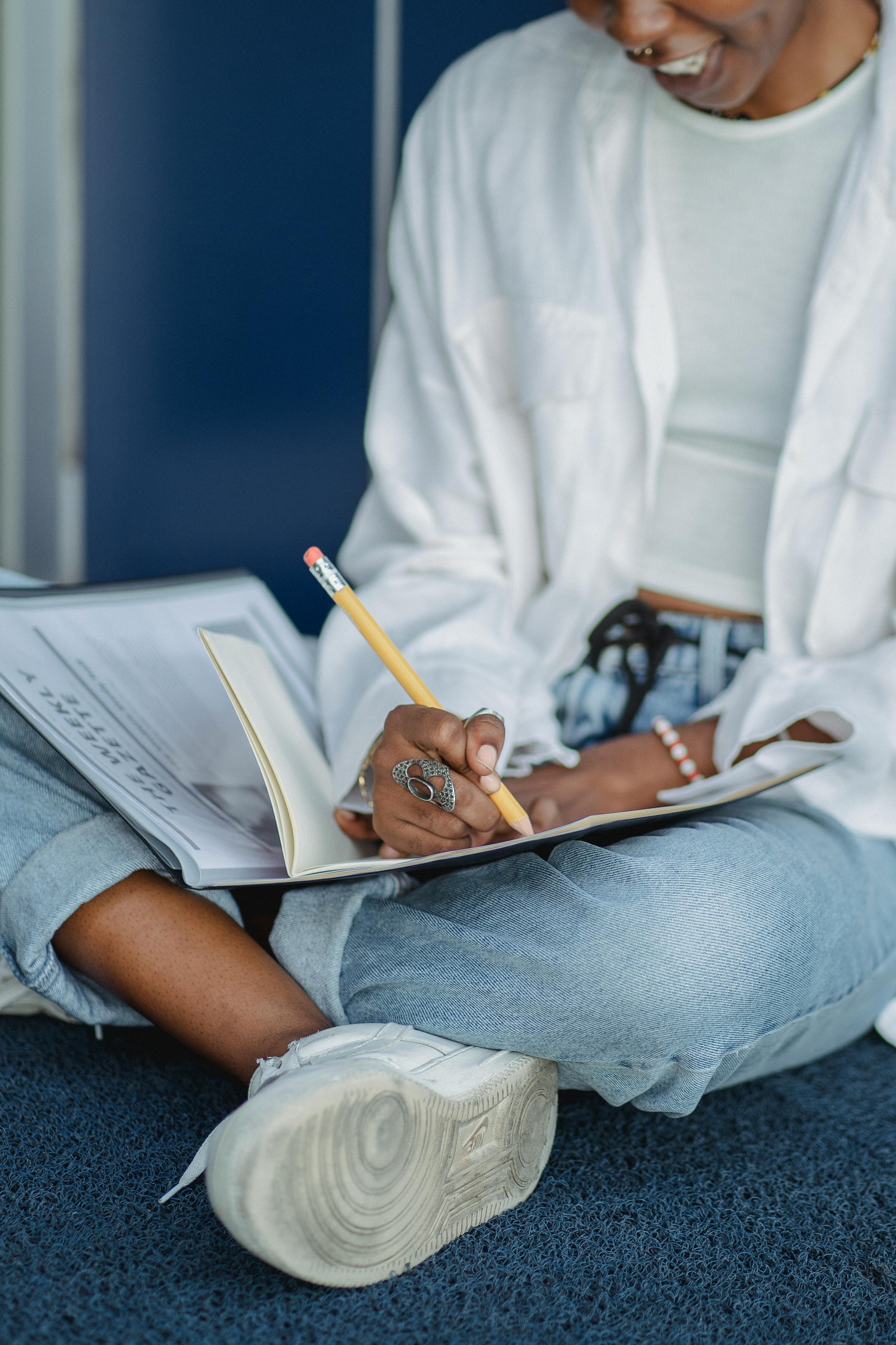 person sitting with notebook