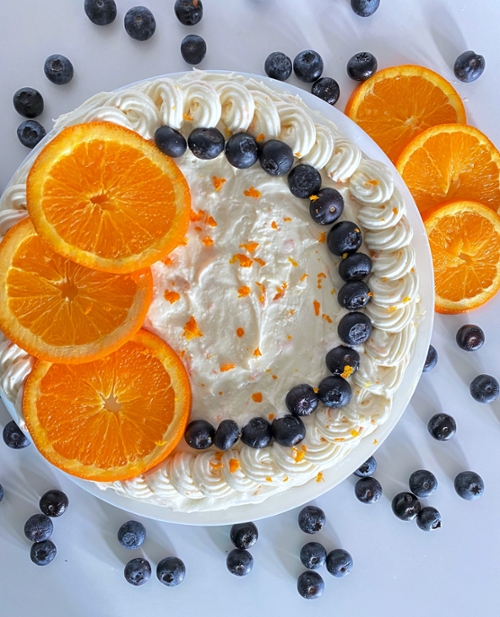 Blueberry and orange cake with white buttercream icing.