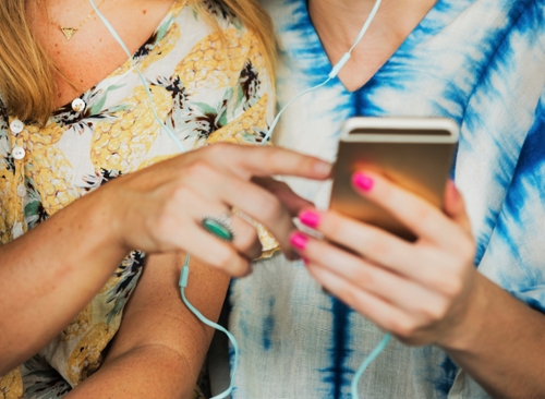 two girls listening to music