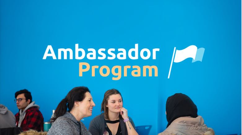 picture of people sitting in front of ambassador program logo