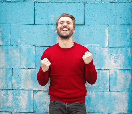 Happy man in front of blue background. 