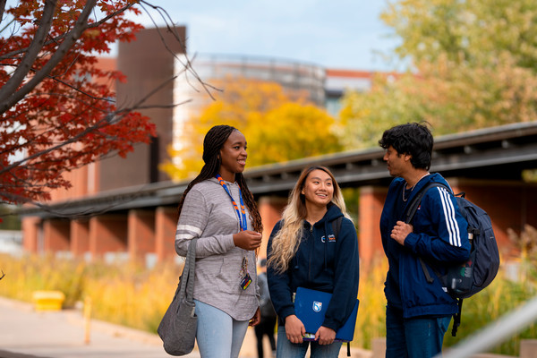 three students chatting on north campus