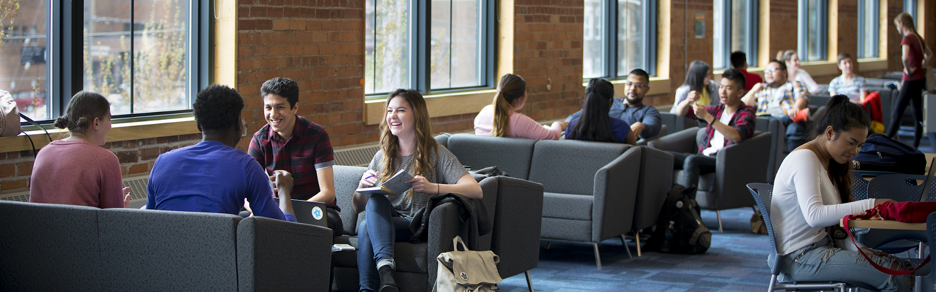 Students interacting on couches in the foyer at the Downtown Campus.