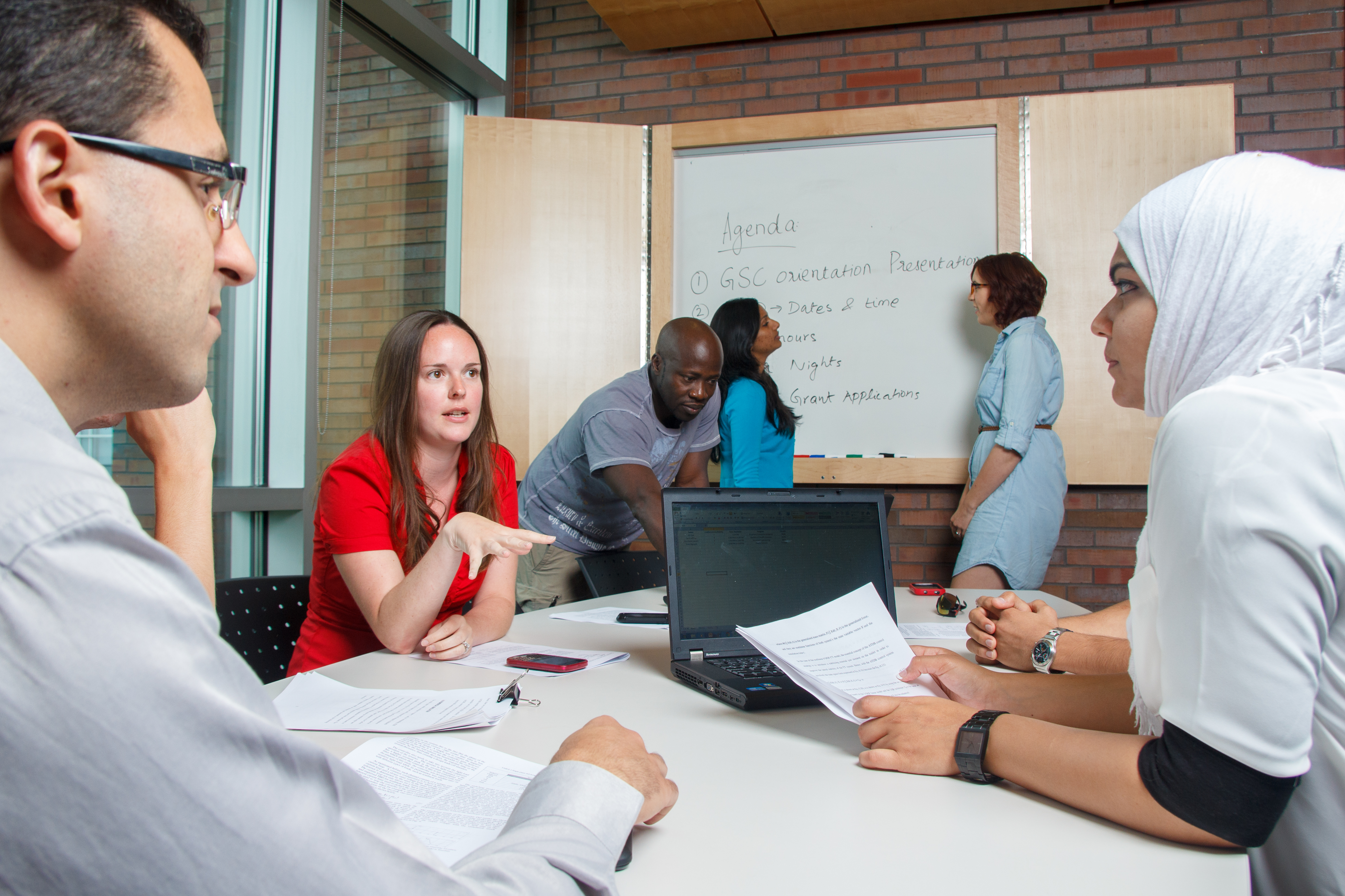 Students receiving academic support in a meeting room