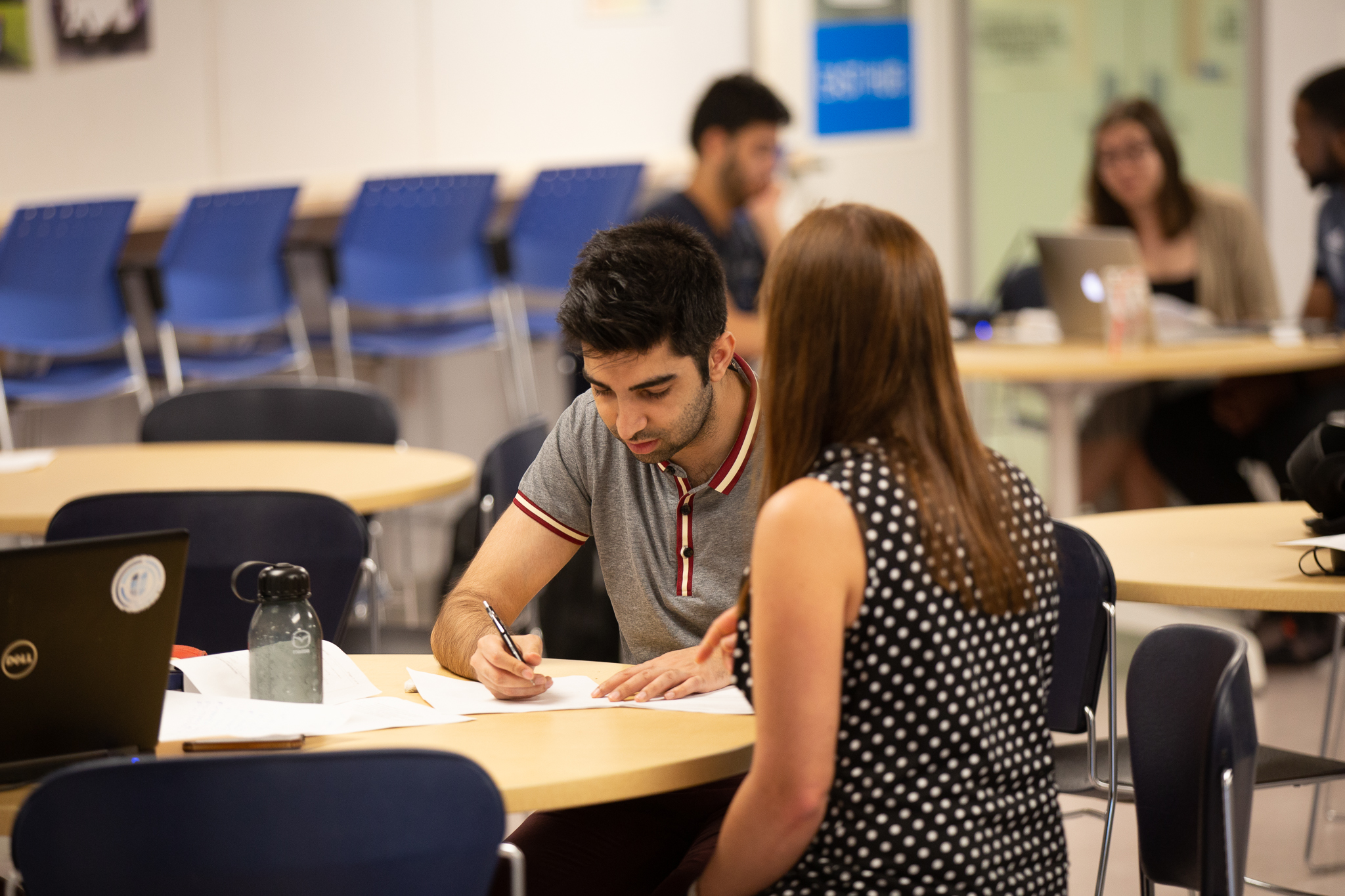 Students sitting around a table studying.