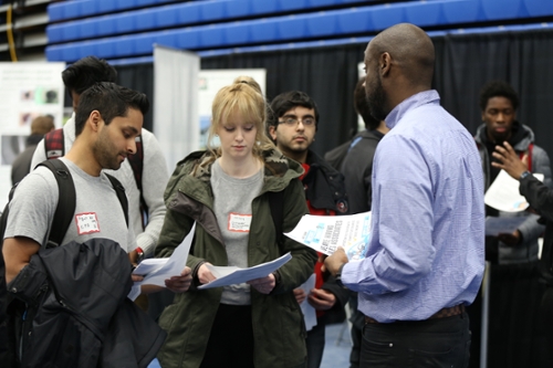 Students speaking with a representative at the career fair