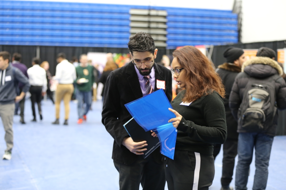 Student talking with company representative at the university job fair