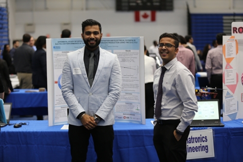 Two students standing in front of their booth