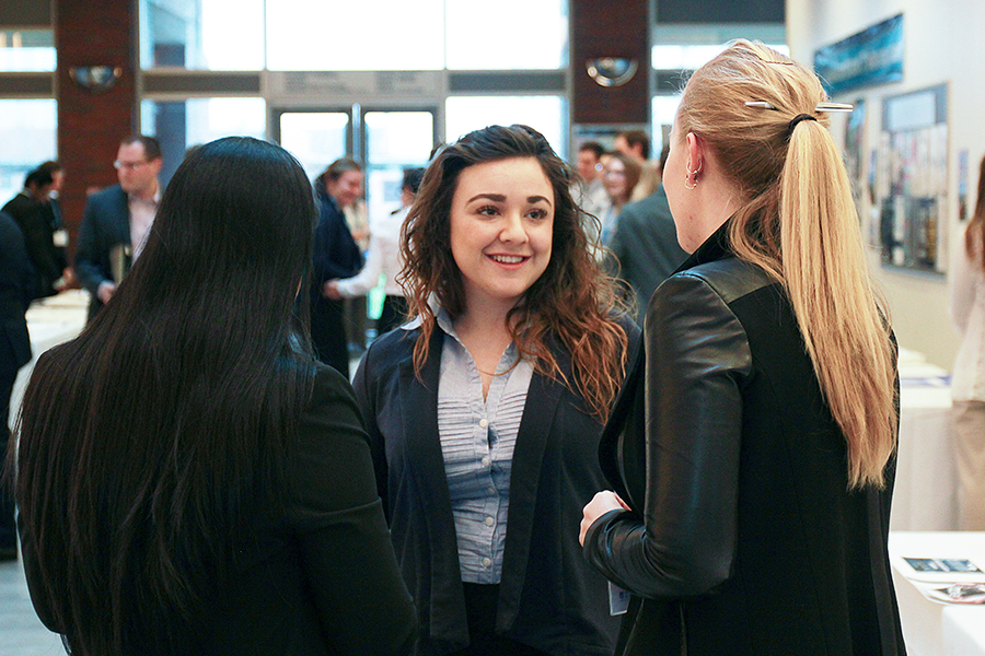 Students speaking with a representative at the information session