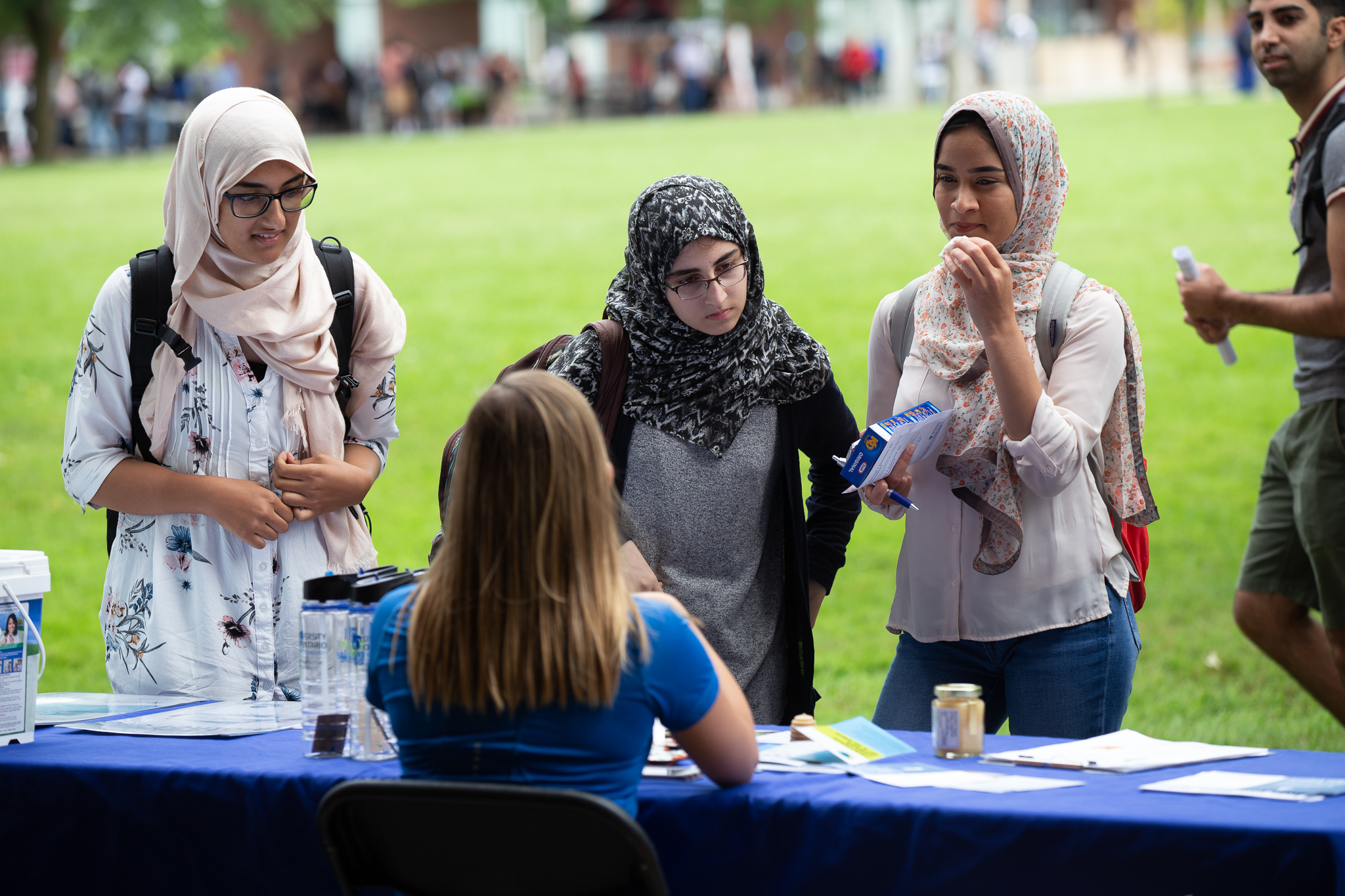 students talking to staff at a booth