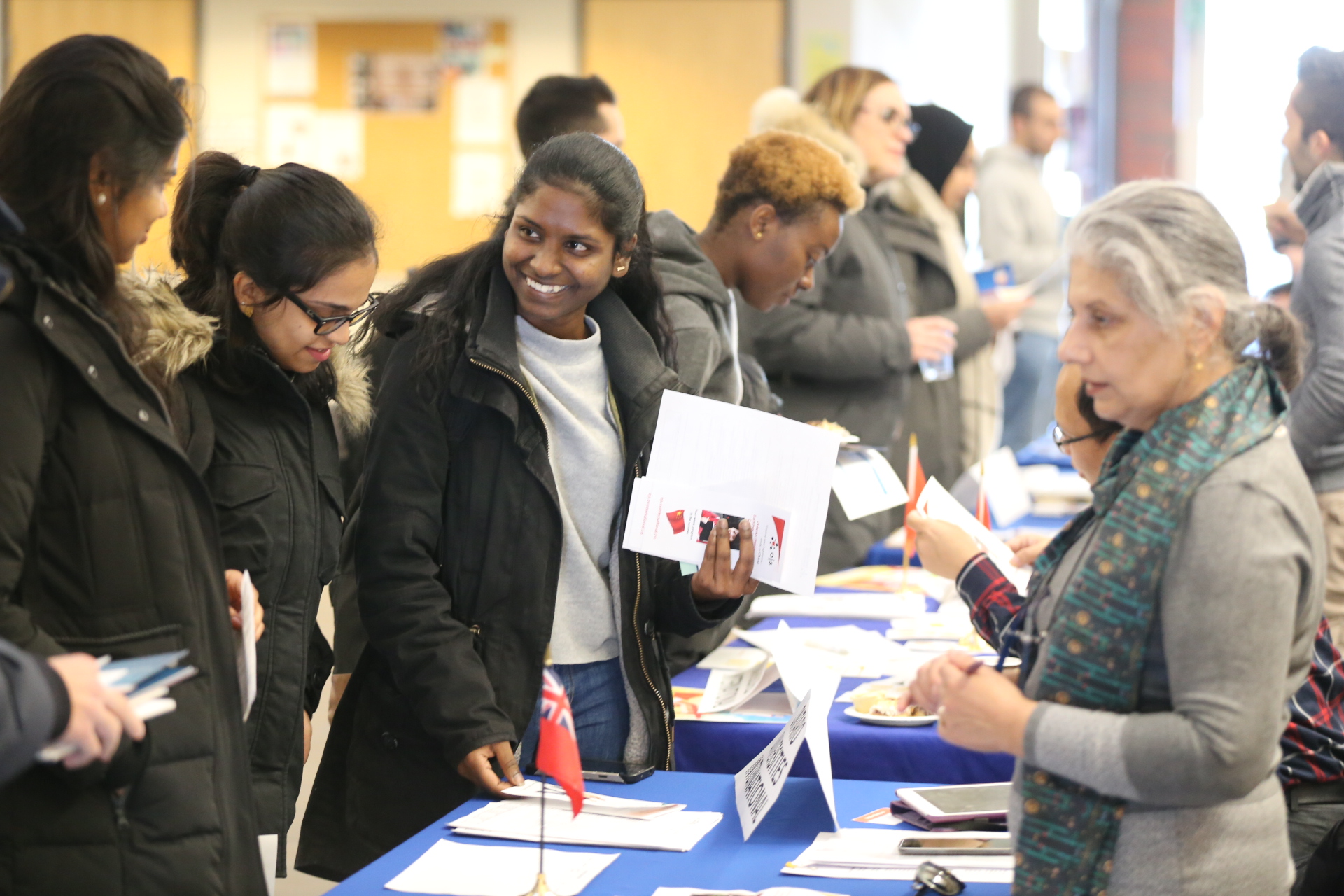 students talking to representative at a table