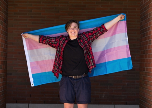 Declan holding a trans pride flag