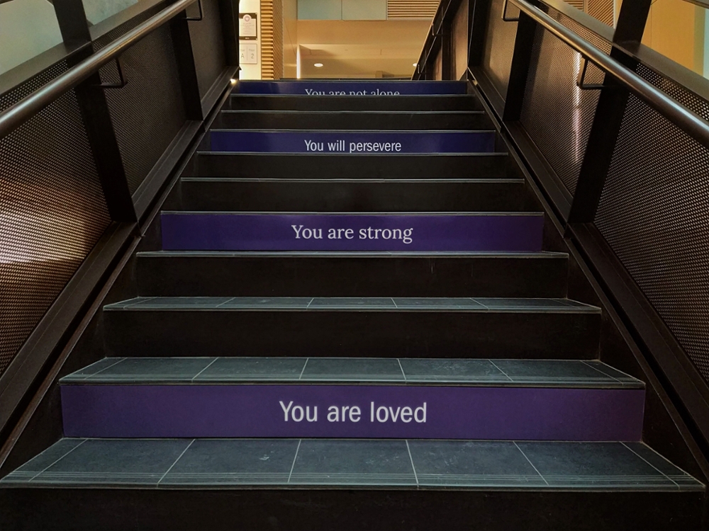 Stairs that say "You are loved", "You are strong" and "You will preserve" 