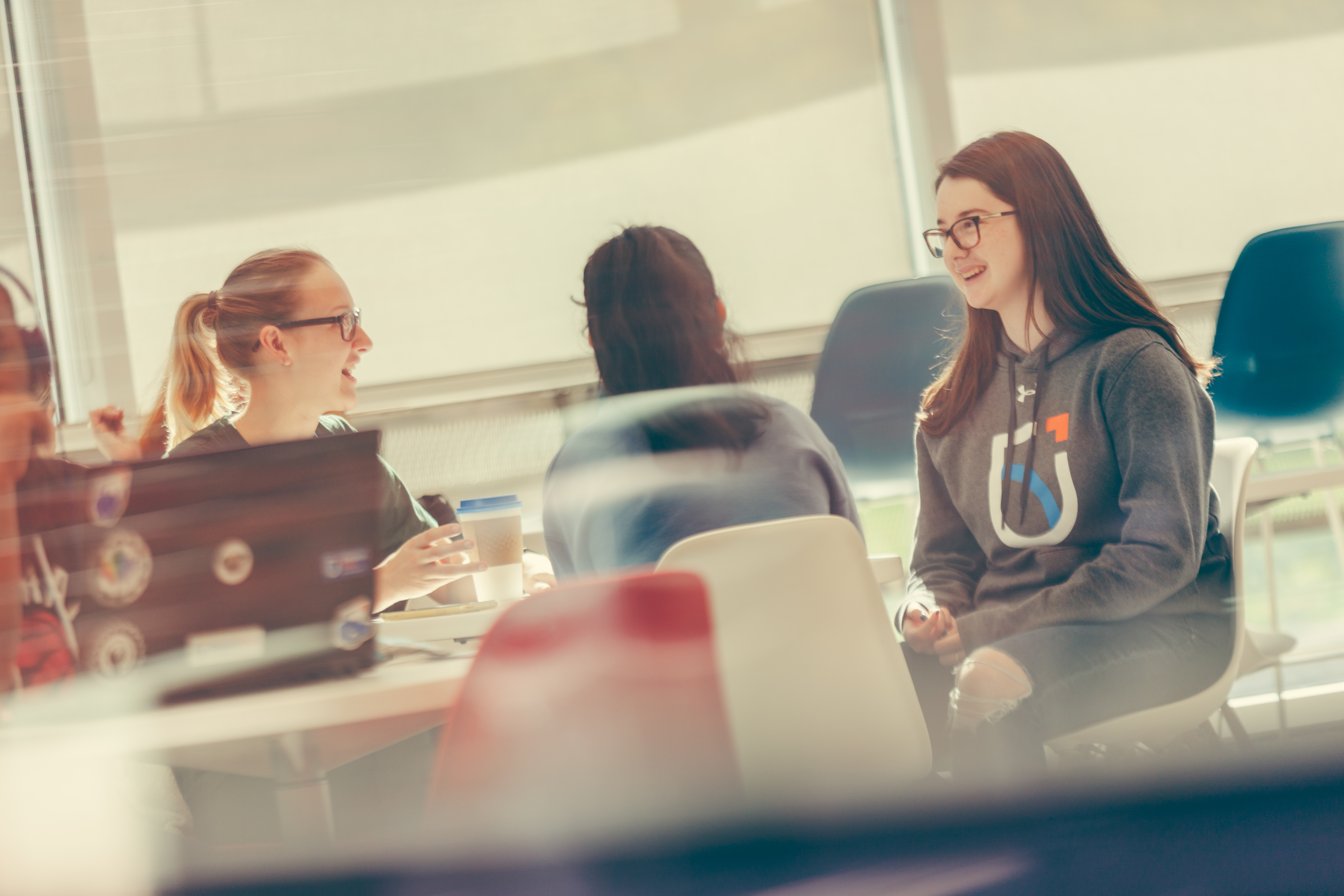 Three students working together in a lab.