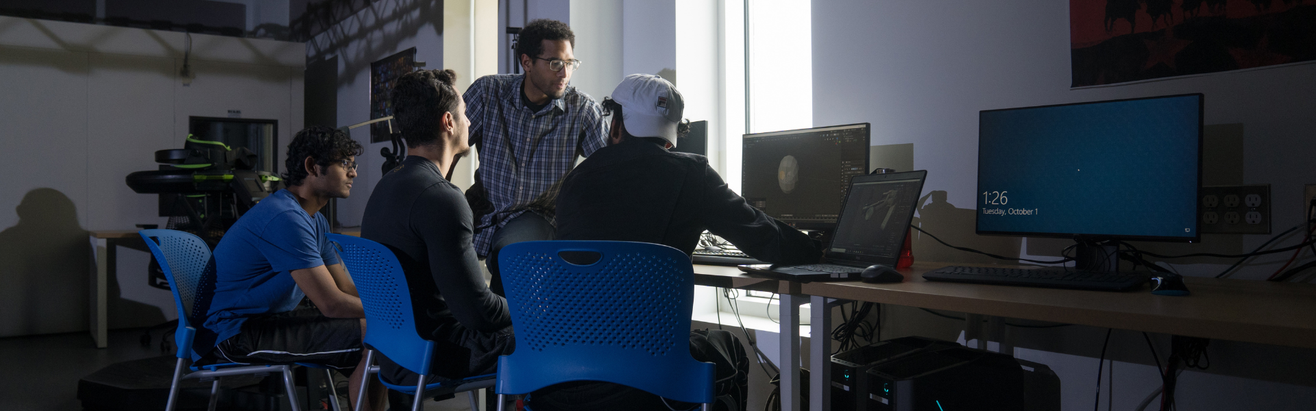 Students working at a computer on campus