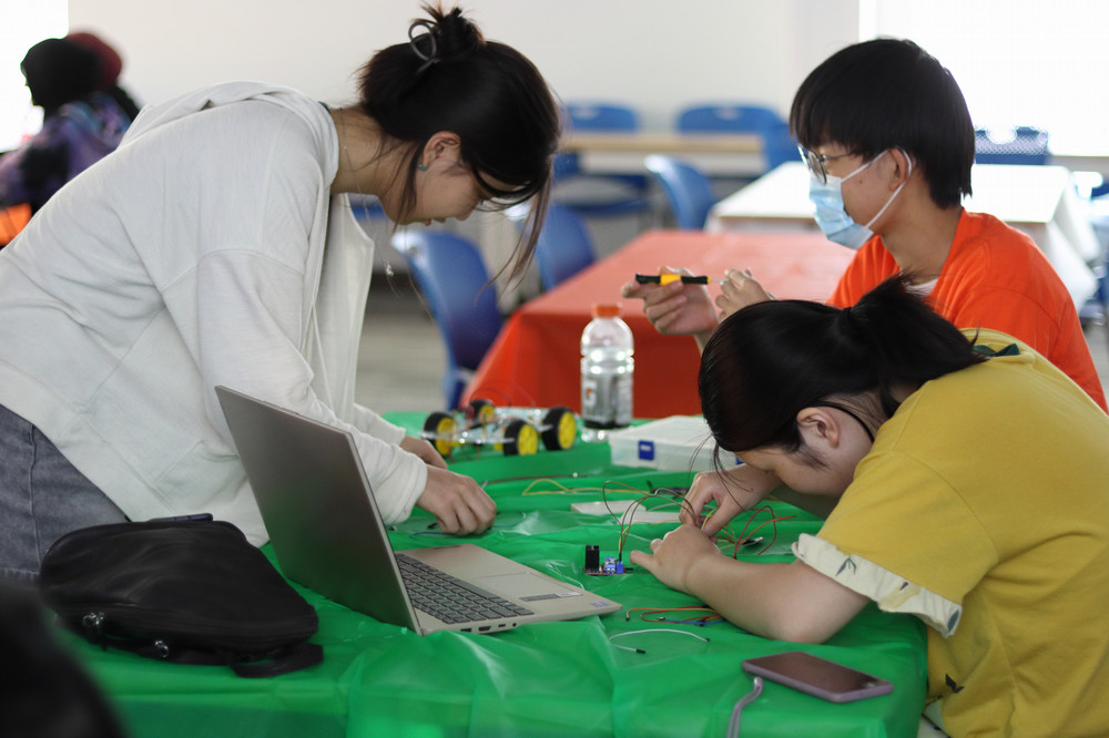 A group of students working with consumable materials at a table