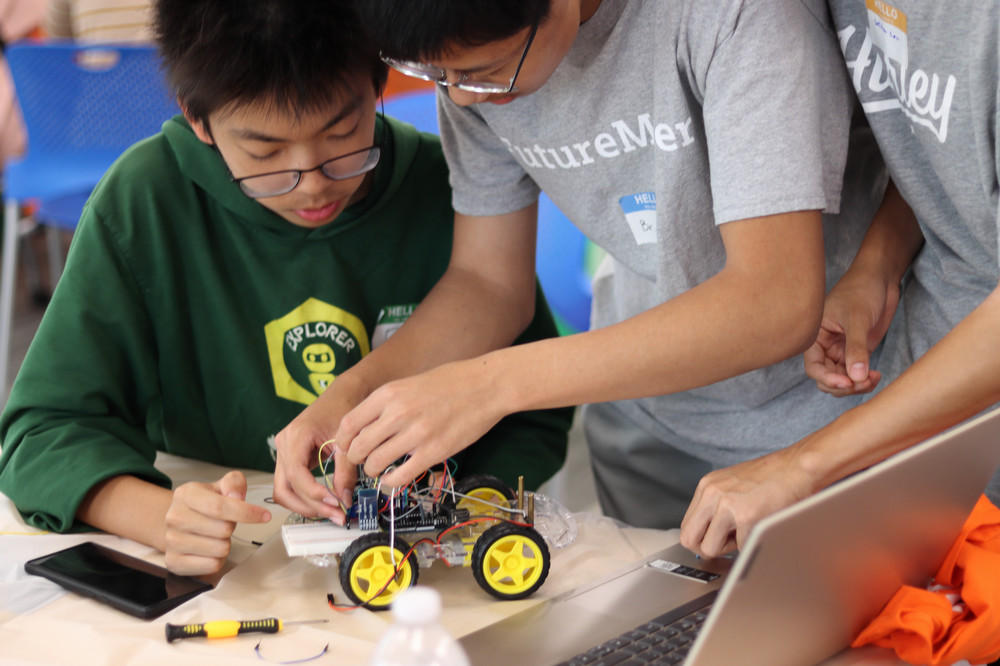 two students working on a robotic car