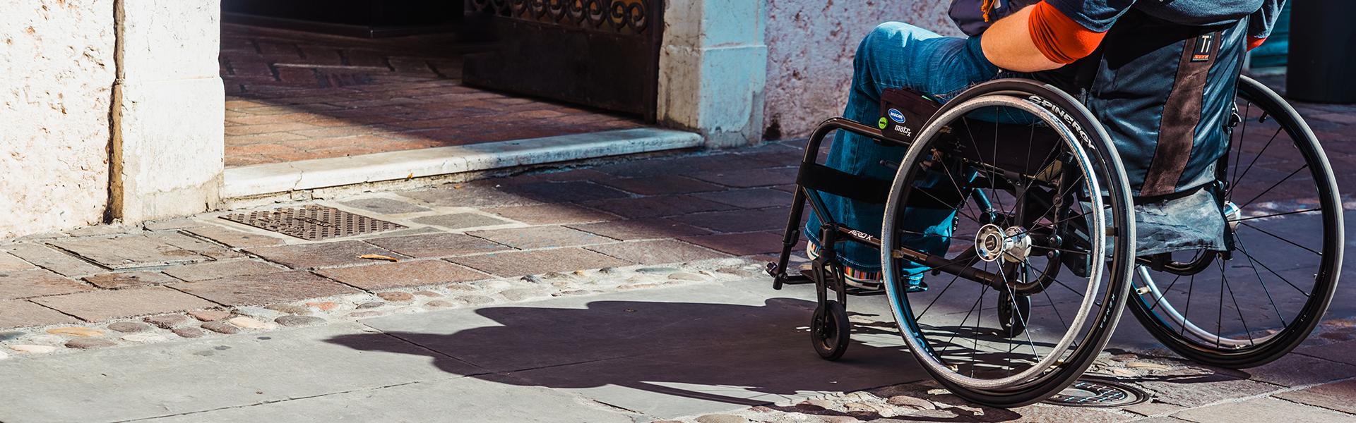 a person in a wheel chair looking into an inaccessible location 