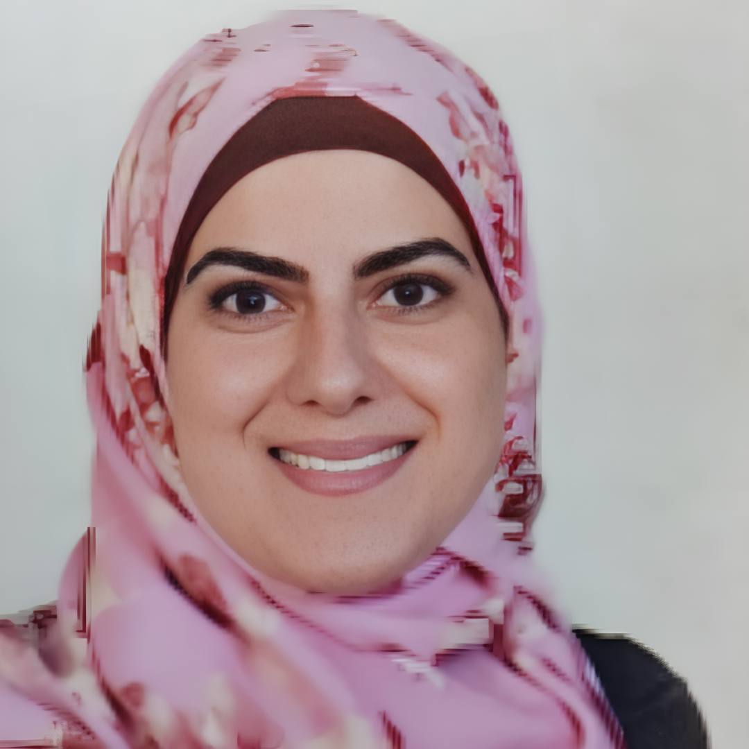 A smiling woman wearing a pink patterned hijab.