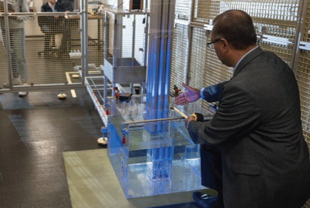 A person working at a desk in the innovation studio on a robot mechano kit