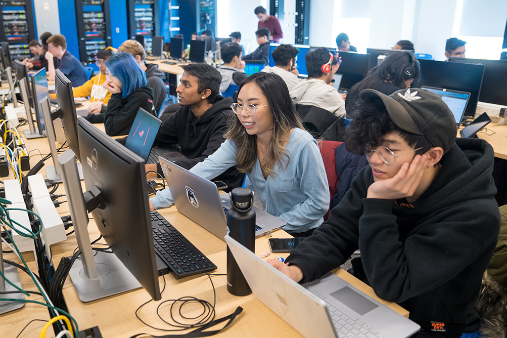 A classroom full of students working on computers.