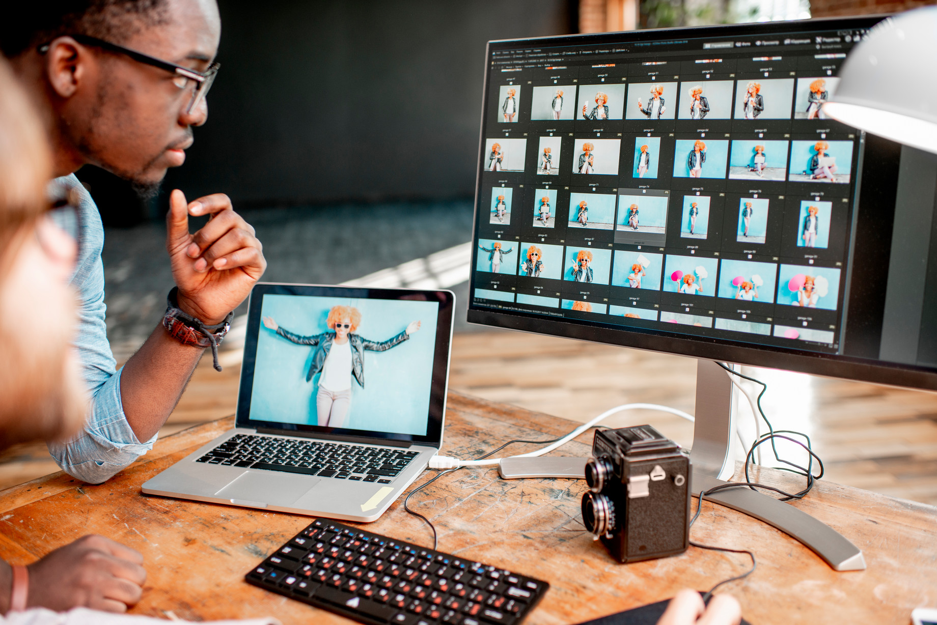 Photo of two photographers working on a computer.