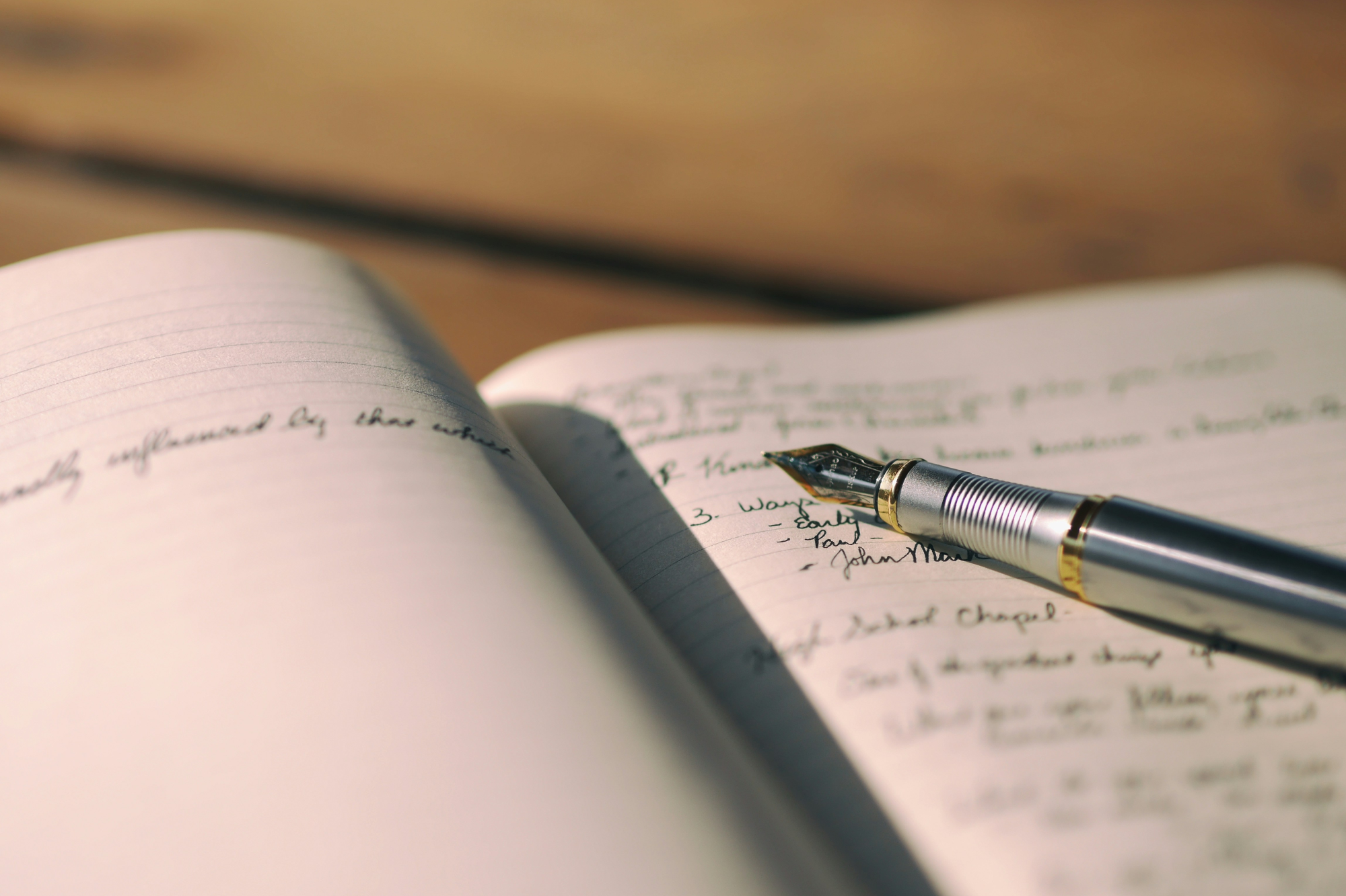 Pen writing in notebook