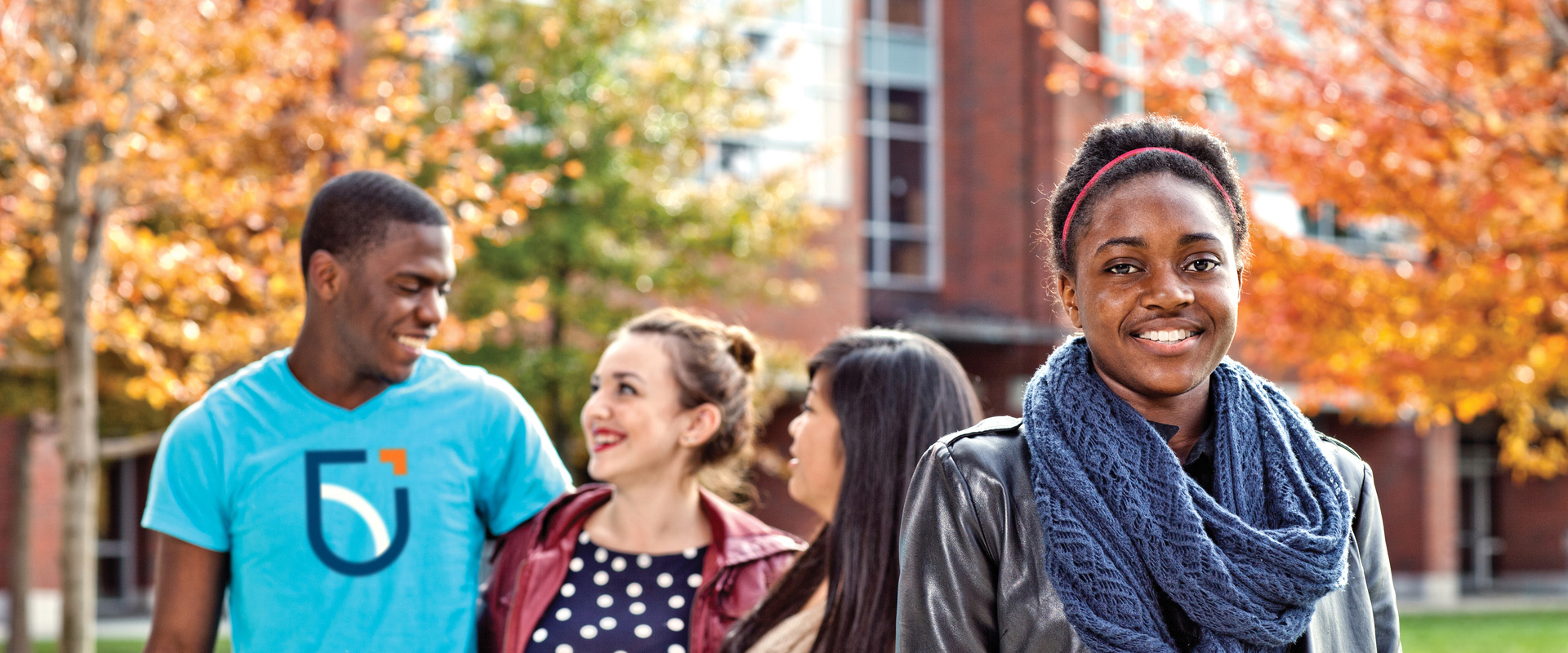 Students smiling in Polonsky Commons in the Fall