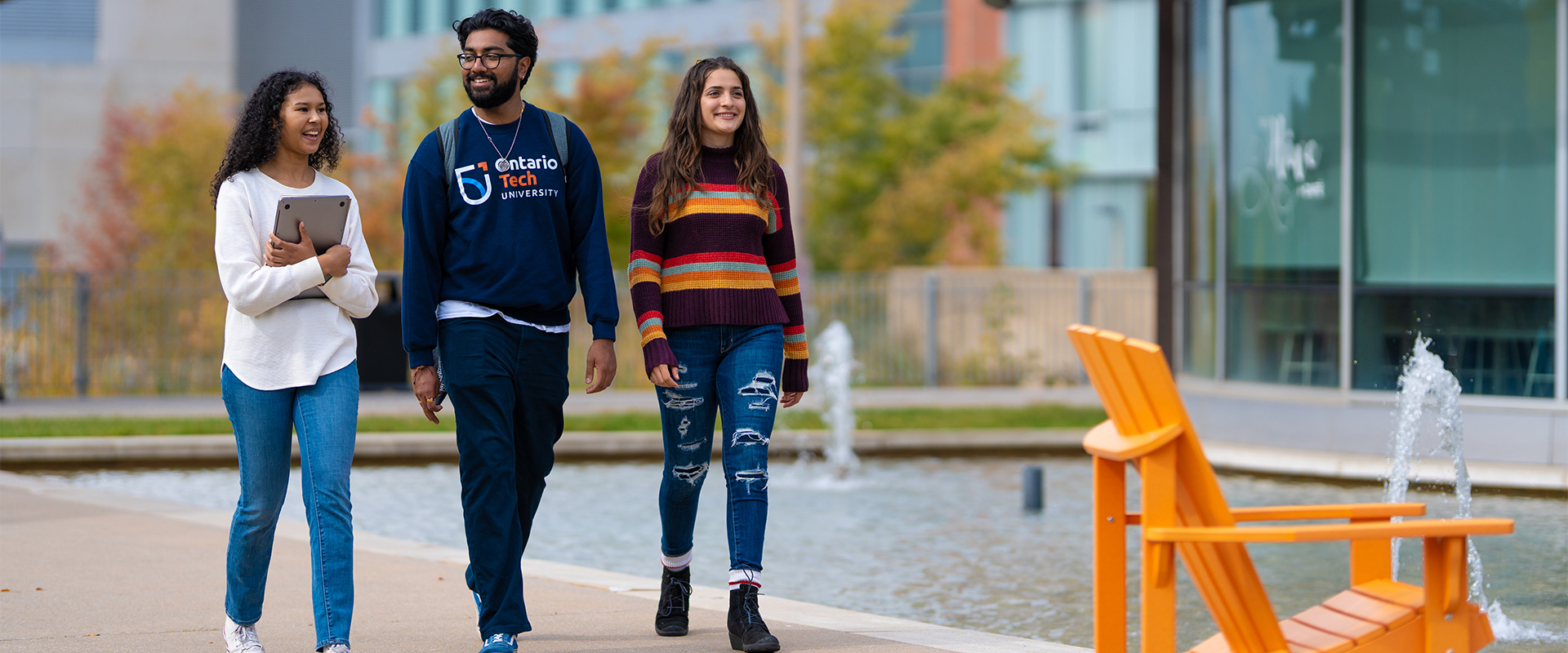 Students walking outside in Polonsky Commons in the fall