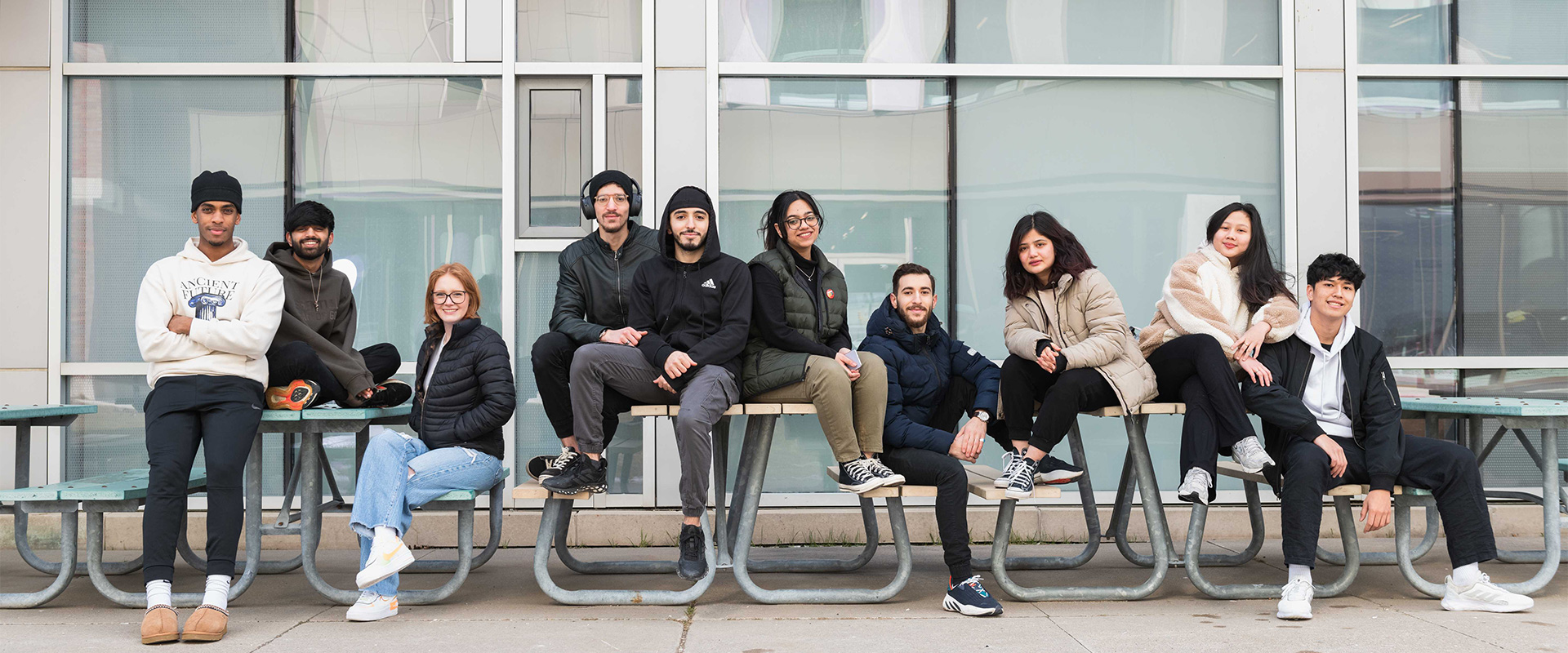 Students sitting outside Shawenjigewining Hall