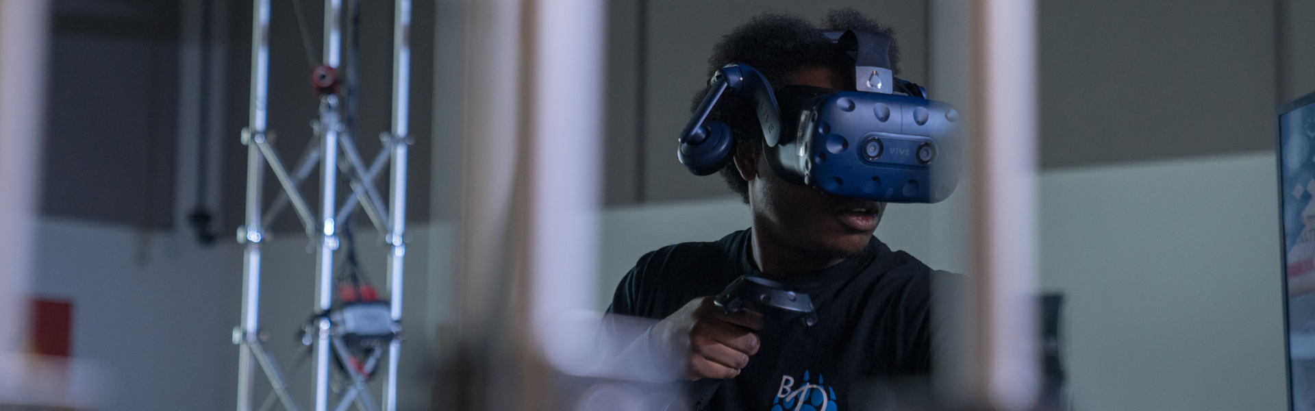 Student using VR gear in game development lab