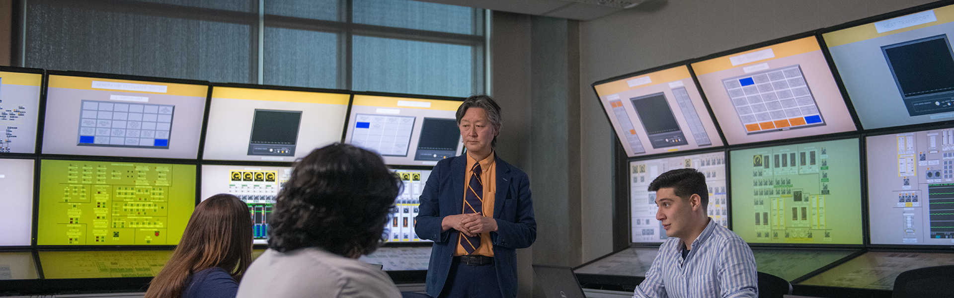 a professor is giving a lesson to a class of students